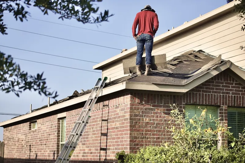 Professional roofer working on a residential roof in Harbor Bluffs